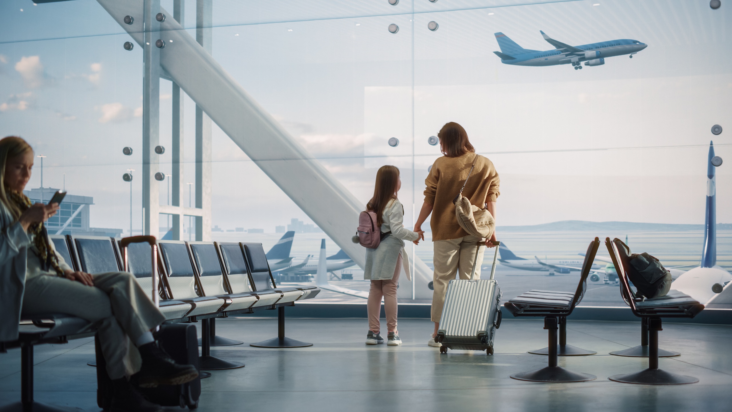 Airport Terminal: Beautiful Mother and Cute Little Daughter Wait